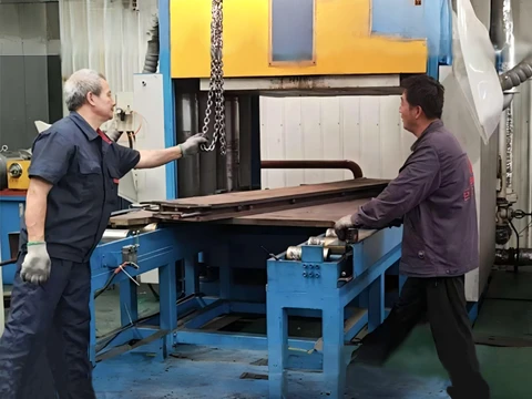 Two workers are processing production