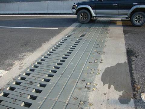 A car is passing through the bridge that is connected with finger expansion joints.