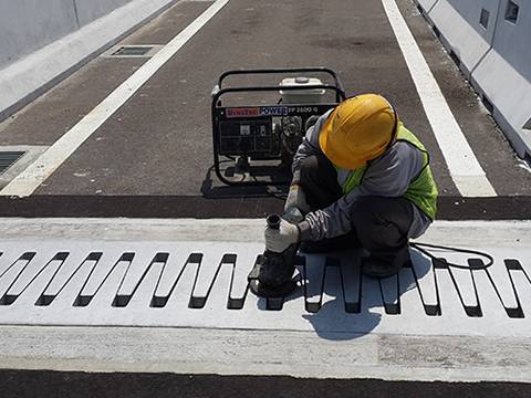 A worker is setting the finger expansion joints in the end of bridge.